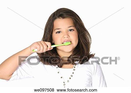 Cute Caucasion girl brushing her teeth isolated on a white background View Large Photo Image Stock Photo - Cute Caucasion girl brushing her teeth isolated on a white background. Fotosearch