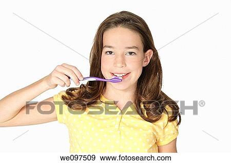 Cute Caucasion girl brushing her teeth isolated on a white background View Large Photo Image Stock Photo - Cute Caucasion girl brushing her teeth isolated on a white background. Fotosearch