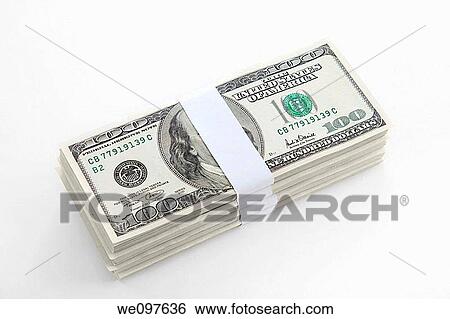 Stock Photograph - Cutout of a pile of US bank notes on white background. Fotosearch