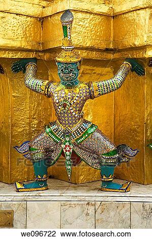 Stock Image - Demons mythical creatures guarding the Golden Stupa also known as Phra Sri Ratana Chedi - Grand Palace Bangkok Thailand. Fotosearch