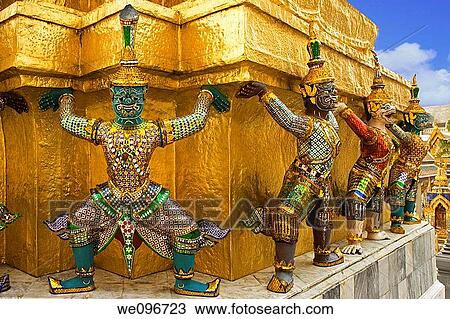 Stock Image - Demons mythical creatures guarding the Golden Stupa also known as Phra Sri Ratana Chedi - Grand Palace Bangkok Thailand. Fotosearch