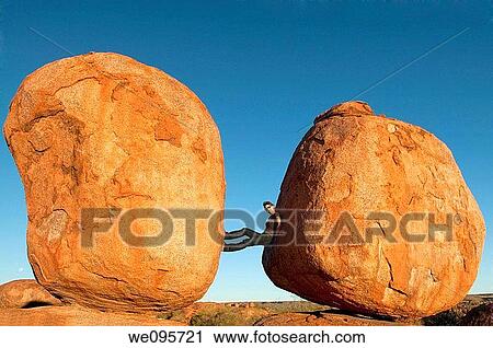 Devils Marbles - Woman between two rocks in Devils Marbles Conservation Reserve, Northern Territory, Australia View Large Photo Image Stock Image - Devils Marbles - Woman between two rocks in Devils Marbles Conservation Reserve, Northern Territory, Australia. Fotosearch