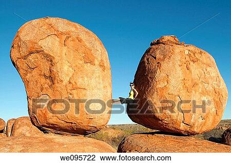 Devils Marbles - Woman between two rocks in Devils Marbles Conservation Reserve, Northern Territory, Australia View Large Photo Image Stock Image - Devils Marbles - Woman between two rocks in Devils Marbles Conservation Reserve, Northern Territory, Australia. Fotosearch