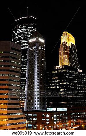 Downtown Minneapolis with lit highrise office towers after dark View Large Photo Image Stock Photo - Downtown Minneapolis with lit highrise office towers after dark. Fotosearch