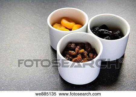 Dried fruits, raisins, apricots, prunes in three white ceramic pots View Large Photo Image Stock Photography - Dried fruits, raisins, apricots, prunes in three white ceramic pots. Fotosearch