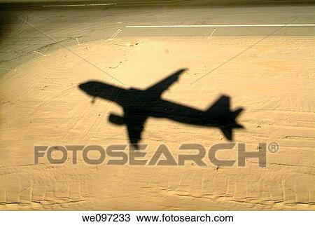 Egypt red sea hurgada airport shadow of a flying airplane ready to land View Large Photo Image Stock Image - Egypt red sea hurgada airport shadow of a flying airplane ready to land. Fotosearch