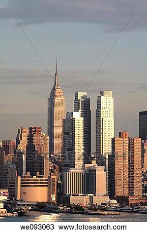 Empire state building and close NY skyline at dusk View Large Photo Image Stock Image - Empire state building and close NY skyline at dusk. Fotosearch