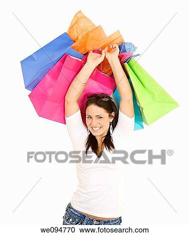 Excited Caucasian woman holding shopping bags and smiling on white background View Large Photo Image Stock Image - Excited Caucasian woman holding shopping bags and smiling on white background. Fotosearch