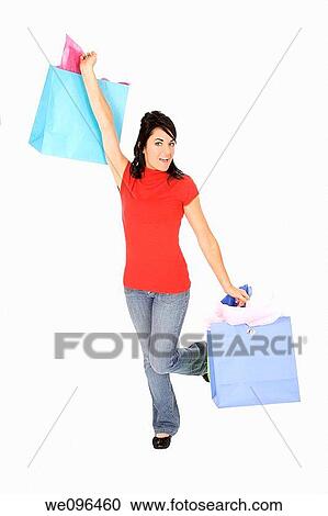 Excited Caucasian woman holding shopping bags and smiling on white background View Large Photo Image Stock Image - Excited Caucasian woman holding shopping bags and smiling on white background. Fotosearch