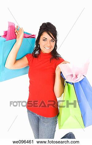Excited Caucasian woman holding shopping bags and smiling on white background View Large Photo Image Stock Image - Excited Caucasian woman holding shopping bags and smiling on white background. Fotosearch