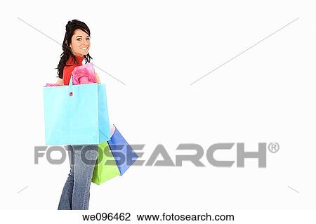 Excited Caucasian woman holding shopping bags and smiling on white background View Large Photo Image Stock Image - Excited Caucasian woman holding shopping bags and smiling on white background. Fotosearch