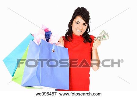 Stock Photo - Excited Caucasian woman holding shopping bags and smiling on white background. Fotosearch
