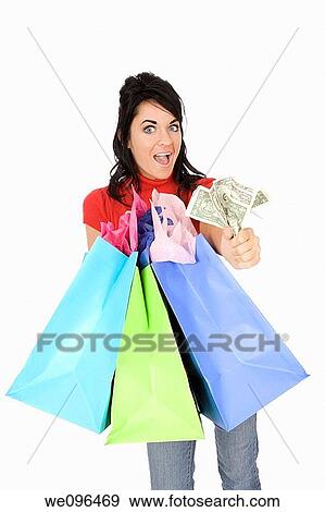 Excited Caucasian woman holding shopping bags and smiling on white background View Large Photo Image Stock Photo - Excited Caucasian woman holding shopping bags and smiling on white background. Fotosearch