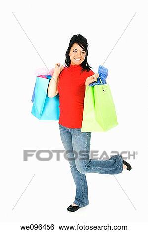 Excited Caucasian woman holding shopping bags and smiling on white background View Large Photo Image Stock Photograph - Excited Caucasian woman holding shopping bags and smiling on white background. Fotosearch