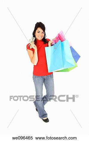 Excited Caucasian woman holding shopping bags and smiling on white background View Large Photo Image Stock Photography - Excited Caucasian woman holding shopping bags and smiling on white background. Fotosearch