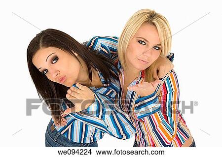 Female Caucasian friends acting silly blowing kisses on white background View Large Photo Image Picture - Female Caucasian friends acting silly blowing kisses on white background. Fotosearch