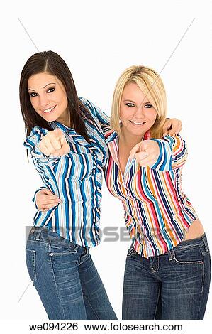 Stock Photograph - Female Caucasian friends acting silly on white background. Fotosearch