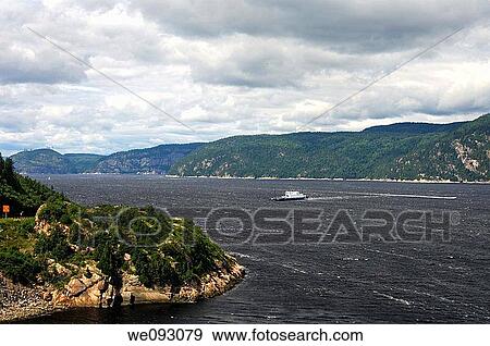 Ferry crossing the Saguenay River between Baie-Ste-Catherine and Tadoussac at its conluence with the St Lawrence River, Tadoussac, Province of Quebec, Canada View Large Photo Image Stock Photo - Ferry crossing the Saguenay River between Baie-Ste-Catherine and Tadoussac at its conluence with the St Lawrence River, Tadoussac, Province of Quebec, Canada. Fotosearch