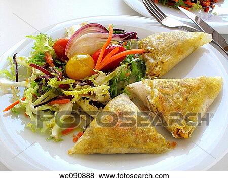 Filo pastry triangles stuffed with rice and meat with salad View Large Photo Image Stock Photo - Filo pastry triangles stuffed with rice and meat with salad. Fotosearch