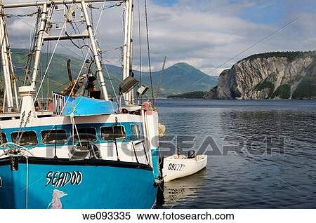 Fishing boat on East Arm Bonne Bay at Norris Point at the end of the day with Shag Cliff View Large Photo Image Stock Photography - Fishing boat on East Arm Bonne Bay at Norris Point at the end of the day with Shag Cliff. Fotosearch