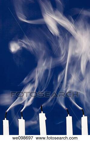 Five white candles against a deep blue background with smoke rising after their flames were blown out The wicks are still red hot View Large Photo Image Stock Photo - Five white candles against a deep blue background with smoke rising after their flames were blown out The wicks are still red hot. Fotosearch