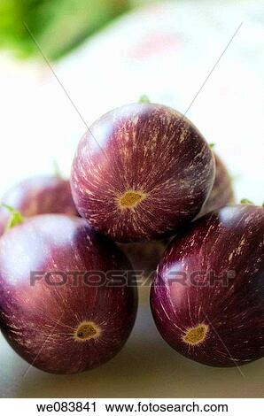 Stock Image - Freshly Harvested Graffiti Eggplants on Cutting Board. Solanum melongena.. Fotosearch