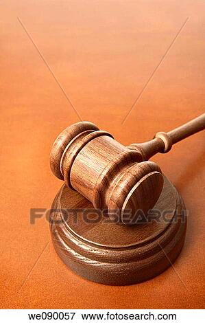 Stock Photo - Gavel on brown leather surface. Fotosearch