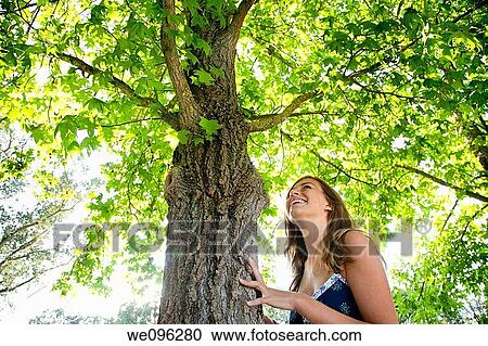Girl hugging a tree View Large Photo Image Stock Image - Girl hugging a tree. Fotosearch