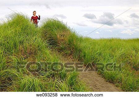 Girl tourist on Port Maitland beach sand dunes with grass Nova Scotia View Large Photo Image Stock Photo - Girl tourist on Port Maitland beach sand dunes with grass Nova Scotia. Fotosearch