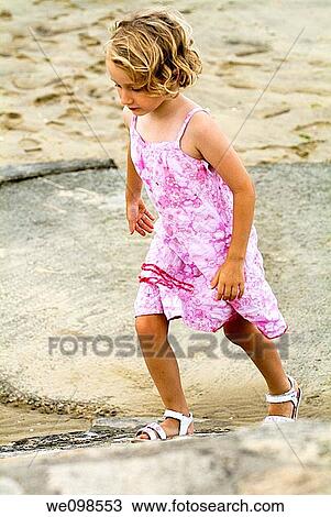 Girl walking on rocks, Bassin d Arcachon in France View Large Photo Image Stock Image - Girl walking on rocks, Bassin d Arcachon in France. Fotosearch