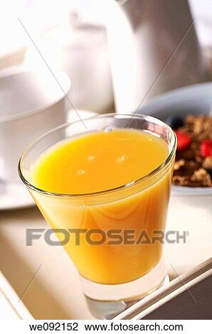 Glass of Orange Juice on breakfast tray View Large Photo Image Stock Image - Glass of Orange Juice on breakfast tray. Fotosearch