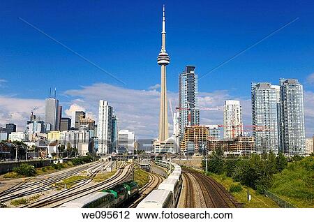 GO trains leaving on rail corridor from downtown Toronto highrise towers View Large Photo Image Stock Image - GO trains leaving on rail corridor from downtown Toronto highrise towers. Fotosearch
