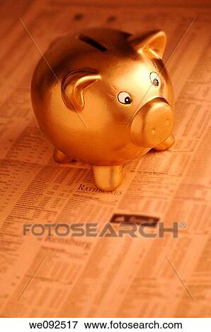 Gold piggy bank on financial newspaper View Large Photo Image Stock Photo - Gold piggy bank on financial newspaper. Fotosearch