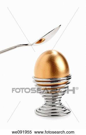 Golden egg in eggcup with spoon View Large Photo Image Stock Photography - Golden egg in eggcup with spoon. Fotosearch