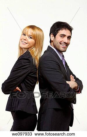 Stock Image - Good looking business people standing on white background with crossed arms. Fotosearch