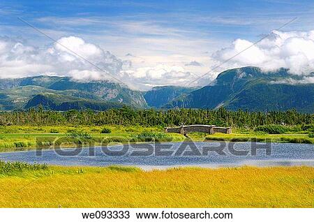 Stock Image - Gros Morne Resort golf course bridge with steep Long Range Mountains of the National Park. Fotosearch