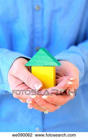 Hands holding blocks in shape of house View Large Photo Image Stock Image - Hands holding blocks in shape of house. Fotosearch