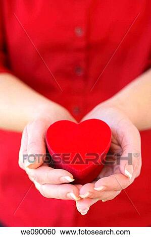 Stock Image - Hands holding heart shaped box. Fotosearch