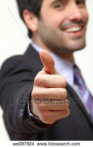 Happy business man giving thumbs up on white background View Large Photo Image Picture - Happy business man giving thumbs up on white background. Fotosearch