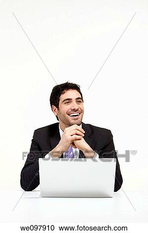 Happy business man working on a laptop View Large Photo Image Stock Image - Happy business man working on a laptop. Fotosearch