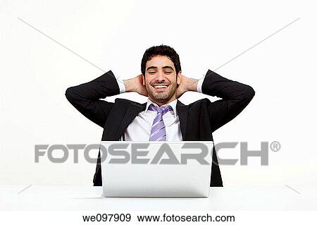 Stock Photo - Happy business man working on a laptop. Fotosearch
