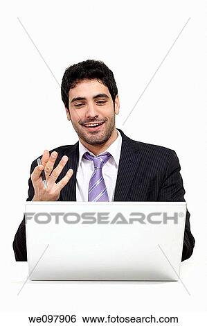Happy business man working on a laptop View Large Photo Image Stock Photograph - Happy business man working on a laptop. Fotosearch