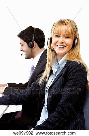 Happy business poeple working in a call centre with headsets View Large Photo Image Stock Image - Happy business poeple working in a call centre with headsets. Fotosearch