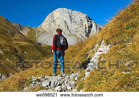 Hiker in the Gelten Valley in front of Mt Spitzhorn, nature reserve Gelten-Iffigen, Bernese Oberland, Switzerland View Large Photo Image Stock Image - Hiker in the Gelten Valley in front of Mt Spitzhorn, nature reserve Gelten-Iffigen, Bernese Oberland, Switzerland. Fotosearch