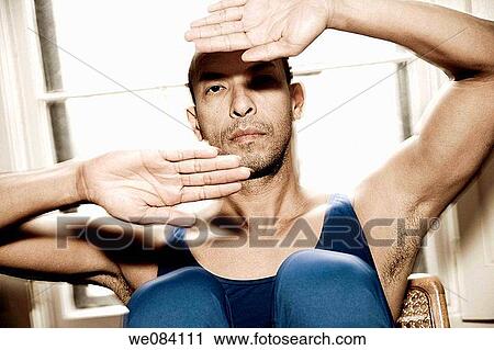 Hispanic man posing in front of a window View Large Photo Image Stock Image - Hispanic man posing in front of a window. Fotosearch