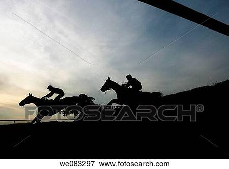 Horses silhouetted as they go over a jump at Towcester Racecourse View Large Photo Image Stock Photo - Horses silhouetted as they go over a jump at Towcester Racecourse. Fotosearch