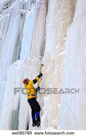 Ice climber looking up while front pointing up a steep wall of ice at Tiffany Falls Ontario View Large Photo Image Stock Photo - Ice climber looking up while front pointing up a steep wall of ice at Tiffany Falls Ontario. Fotosearch
