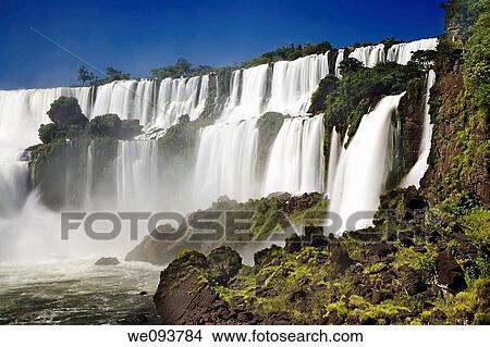 Iguassu Falls is the largest series of waterfalls on the planet, located in Brazil, Argentina, and Paraguay At some times during the year one can see as many as 275 separate waterfalls cascading along the edges of 2, 700 meters 1 6 miles cliffs Argentine View Large Photo Image Picture - Iguassu Falls is the largest series of waterfalls on the planet, located in Brazil, Argentina, and Paraguay At some times during the year one can see as many as 275 separate waterfalls cascading along the edges of 2, 700 meters 1 6 miles cliffs Argentine. Fotosearch