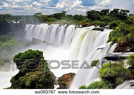 Iguassu Falls is the largest series of waterfalls on the planet, located in Brazil, Argentina, and Paraguay At some times during the year one can see as many as 275 separate waterfalls cascading along the edges of 2, 700 meters 1 6 miles cliffs Argentine View Large Photo Image Stock Photo - Iguassu Falls is the largest series of waterfalls on the planet, located in Brazil, Argentina, and Paraguay At some times during the year one can see as many as 275 separate waterfalls cascading along the edges of 2, 700 meters 1 6 miles cliffs Argentine. Fotosearch