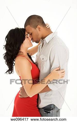 Interracial couple sharing and intimate moment View Large Photo Image Stock Photo - Interracial couple sharing and intimate moment. Fotosearch